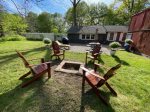 Beautiful fenced in backyard space with BBQ grill, fire pit, and outdoor dining